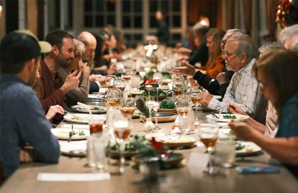 large family gathering at dinner table